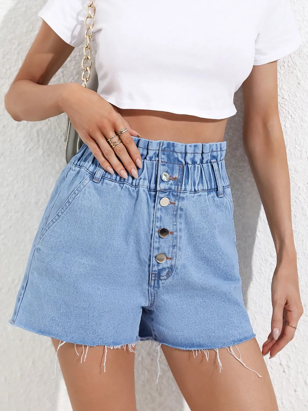 Fashionable high waisted loose and slimming denim shorts with frayed edges