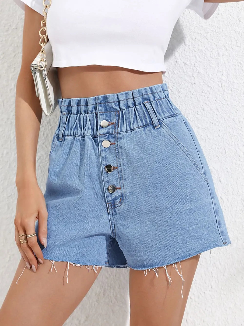 Fashionable high waisted loose and slimming denim shorts with frayed edges