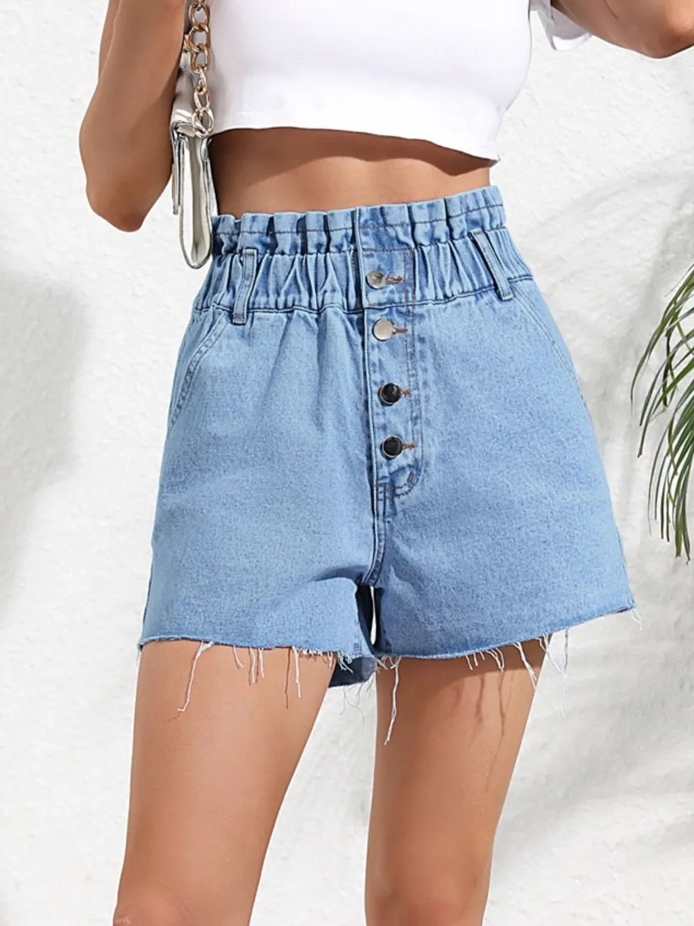 Fashionable high waisted loose and slimming denim shorts with frayed edges